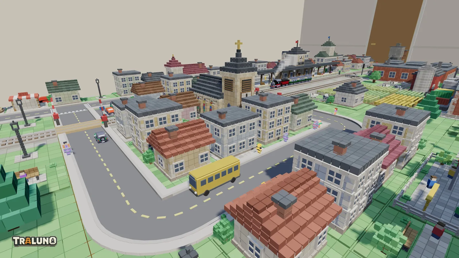 The demo town in morning sun seen from behind the table: cottages with red, brown, green and grey roofs and taller townhouses round a loop road with a yellow bus on it, a level crossing on the left, the church tower in the middle and the station with a steam train behind.