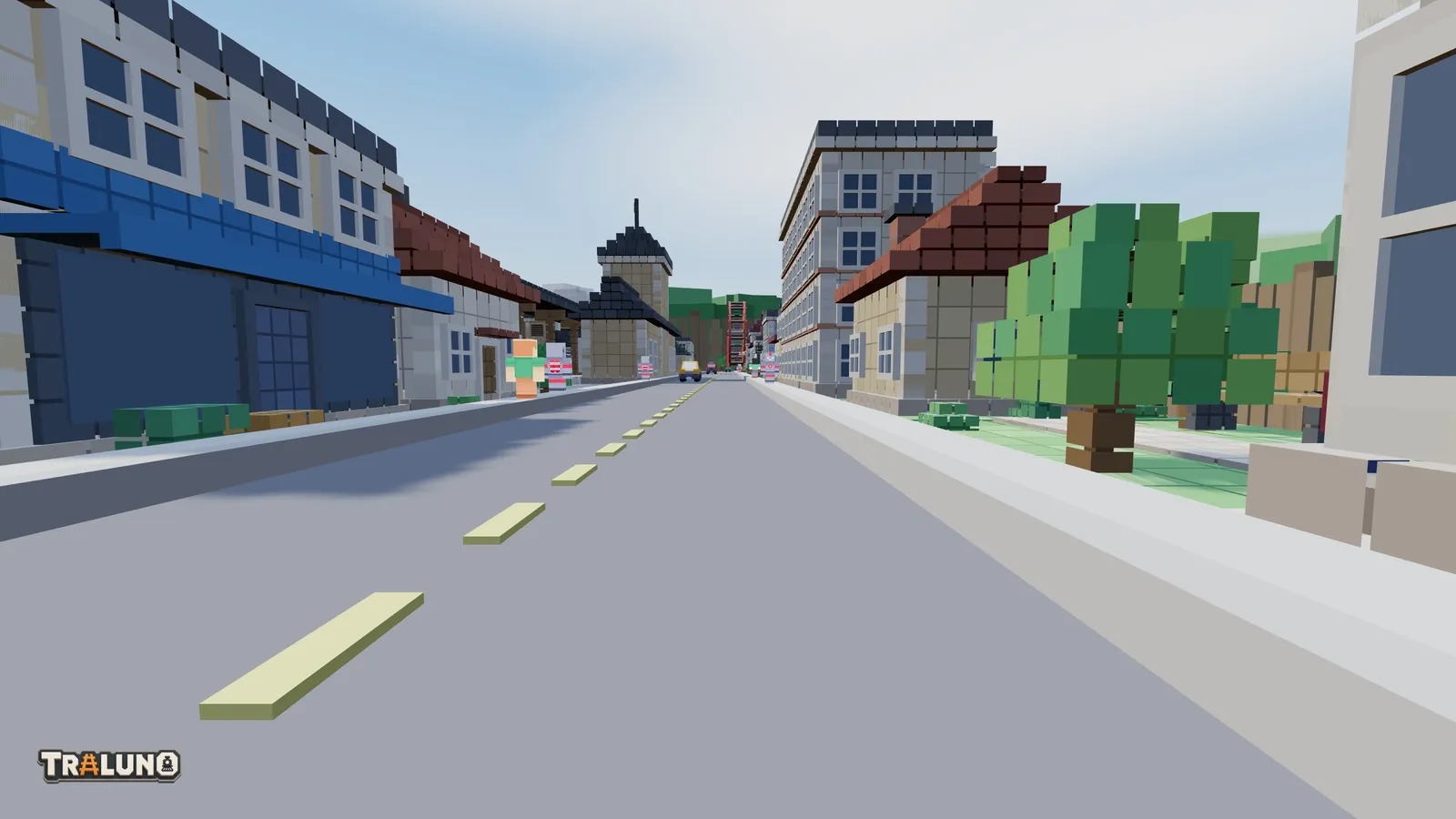 A driver's-eye view down a street of voxel shops and houses, the centre line of the road running away towards the far end of the table