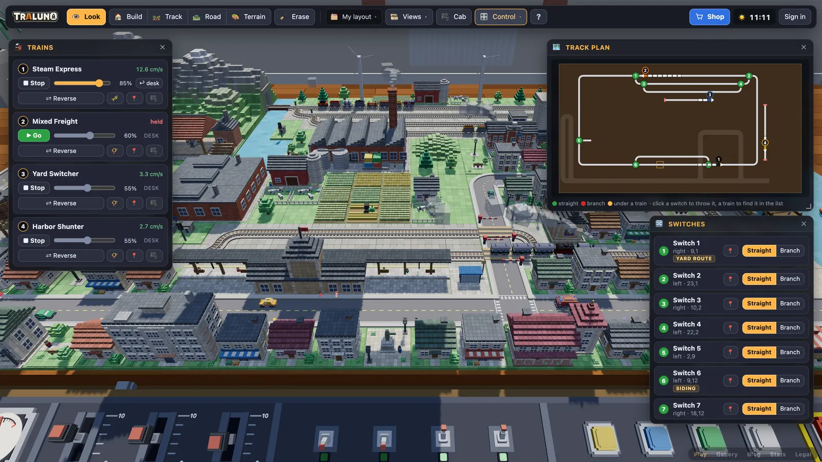 The Trains window, the Switches window and the Track plan open over the demo layout, with the control desk along the bottom of the screen.
