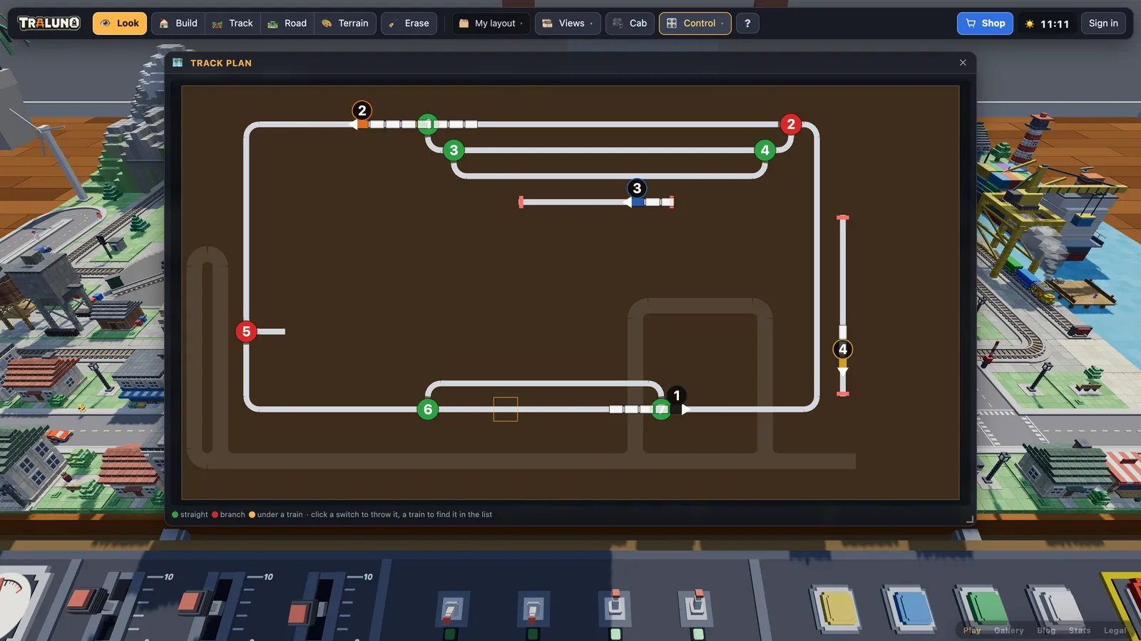 The Track plan window stretched wide: the main line, the yard and the station siding in white, numbered switch discs in green and red, and the four trains drawn car by car with their numbers in circles