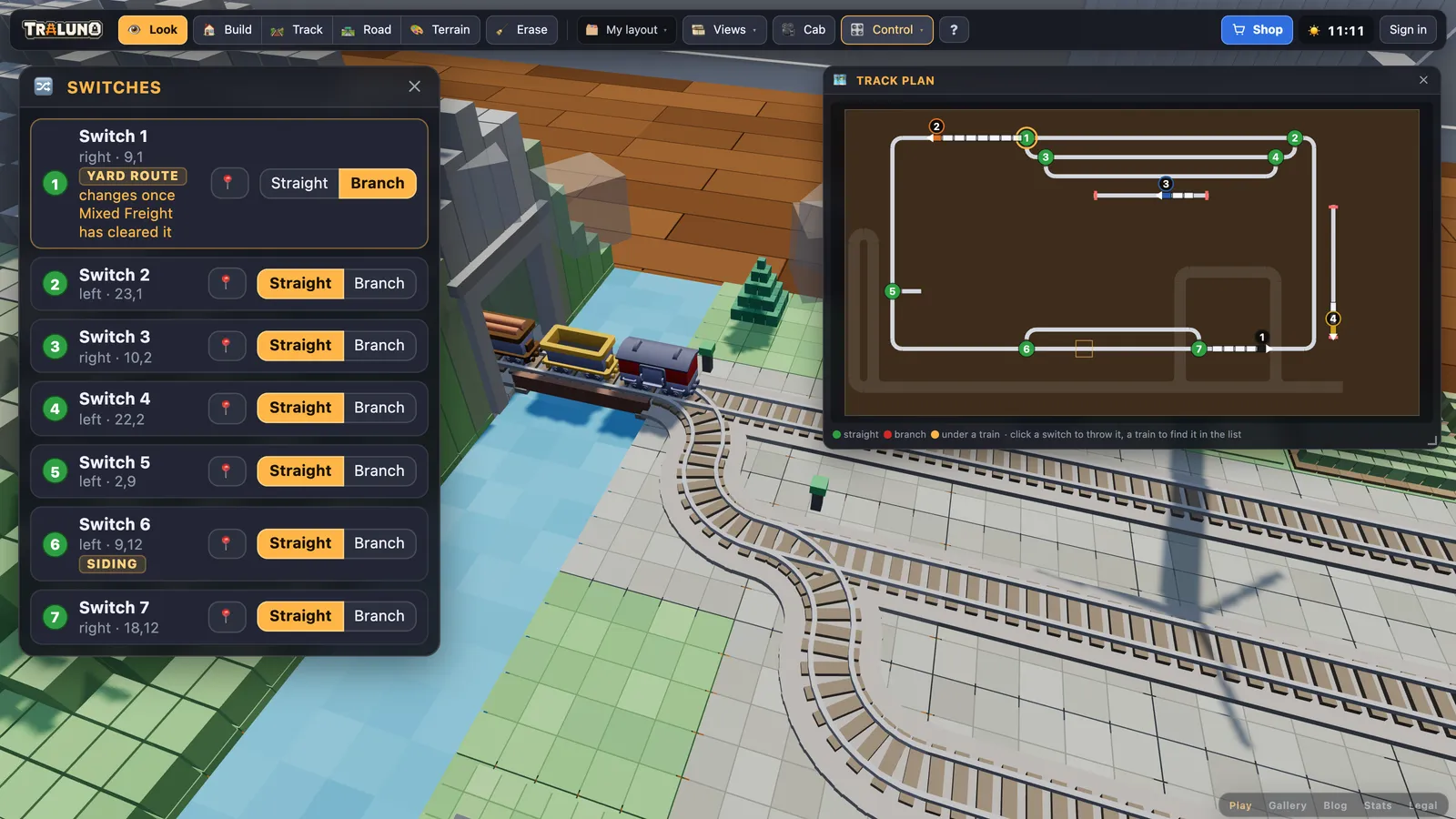 The Switches window with Switch 1 set to Branch and the note changes once Mixed Freight has cleared it, beside the Track plan where disc 1 has an amber ring, over a view of the freight crossing the turnout