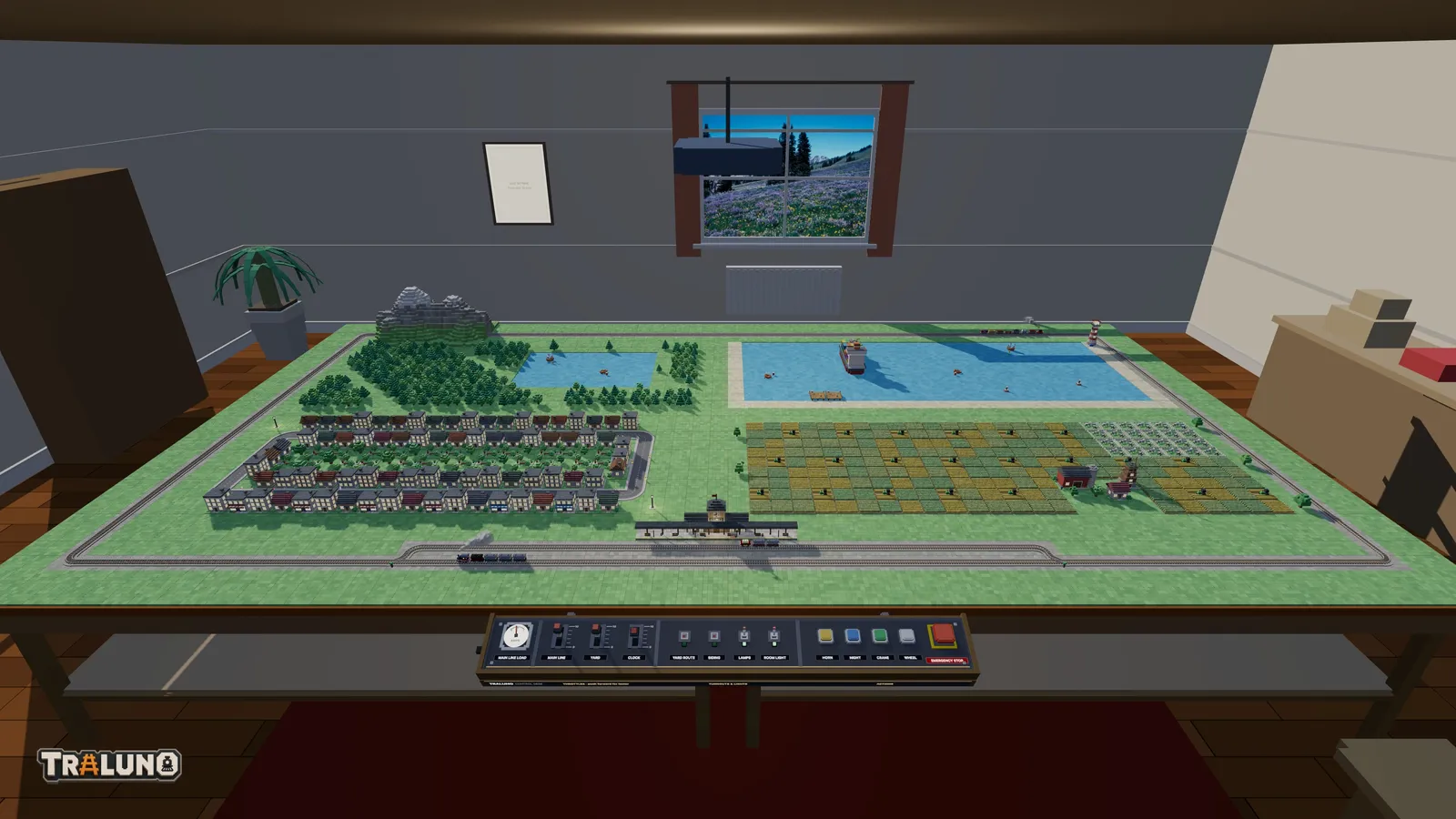 Four tables pushed together in a two by two square in the hobby room, a main line laid round all of them, woods and a lake on one table, a harbour on the next, a town and farmland in front, and the control desk along the front edge.