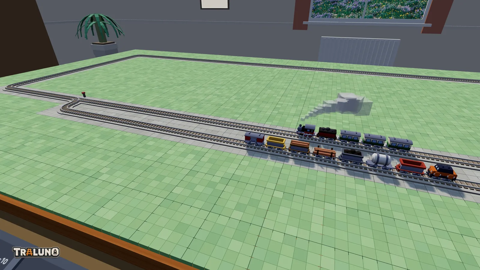 A freight train waiting on a passing loop beside the front straight while the Steam Express runs past it on the main line.