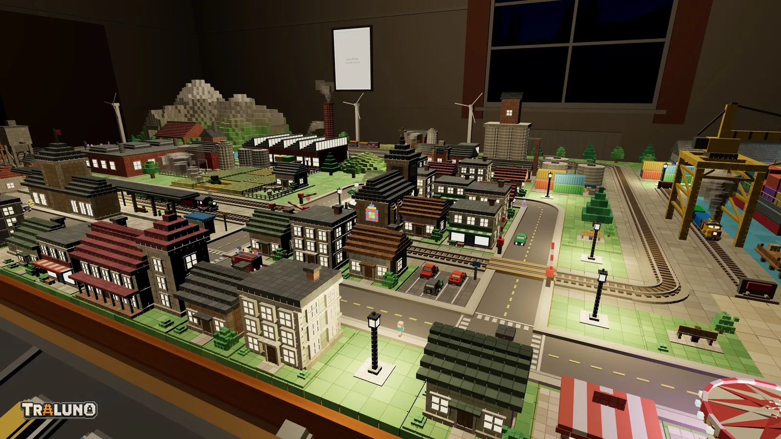 The Traluno demo town at nine in the evening from the front-right corner of the table: rows of houses with lit windows, street lamps throwing light on the pavements, the church's coloured window glowing, the harbour crane on the right and a striped fairground awning in the corner.