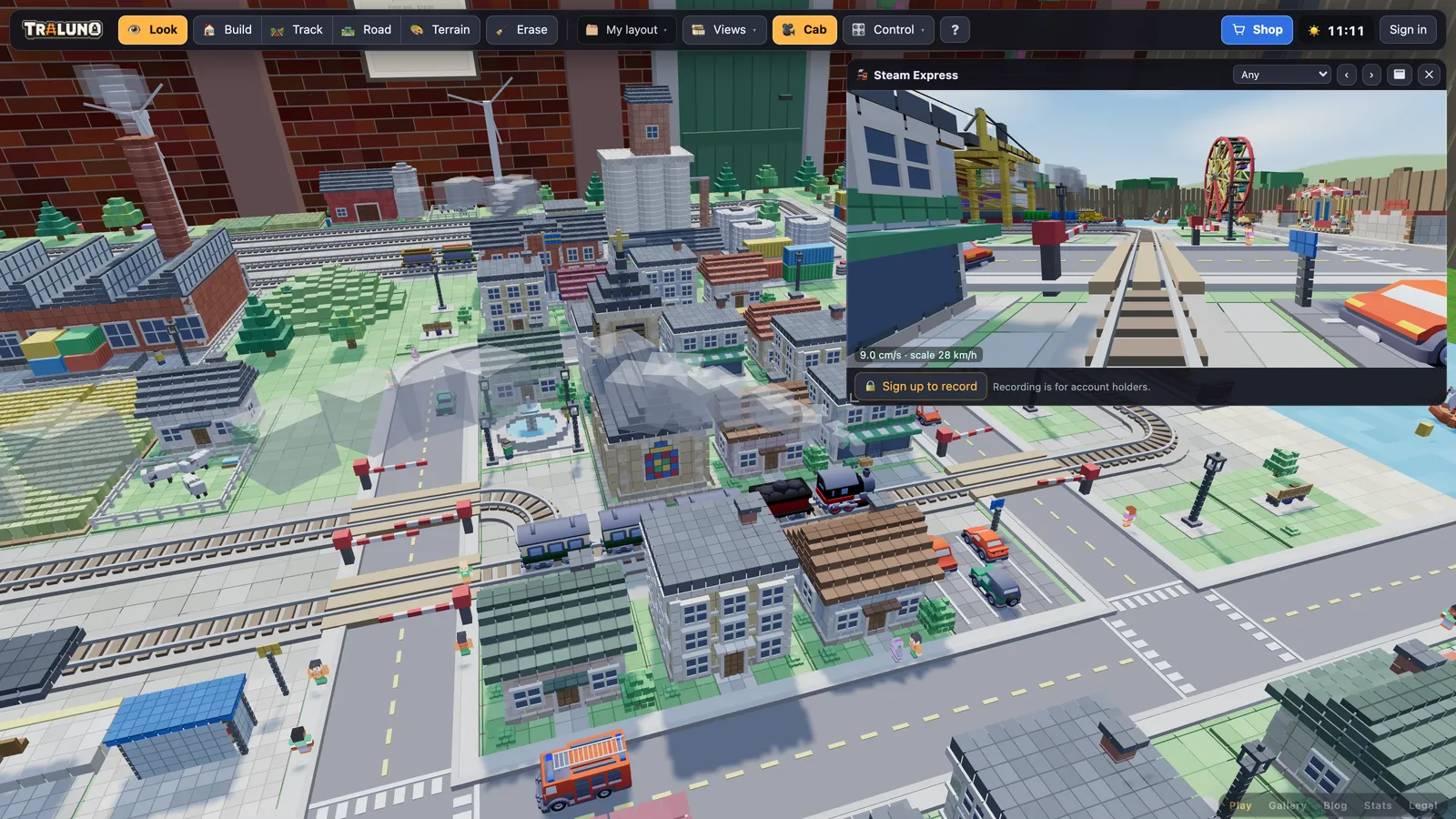 The game's main view of the town with the cab window open in the top right corner, showing the view from the front of the Steam Express as it runs towards a level crossing.