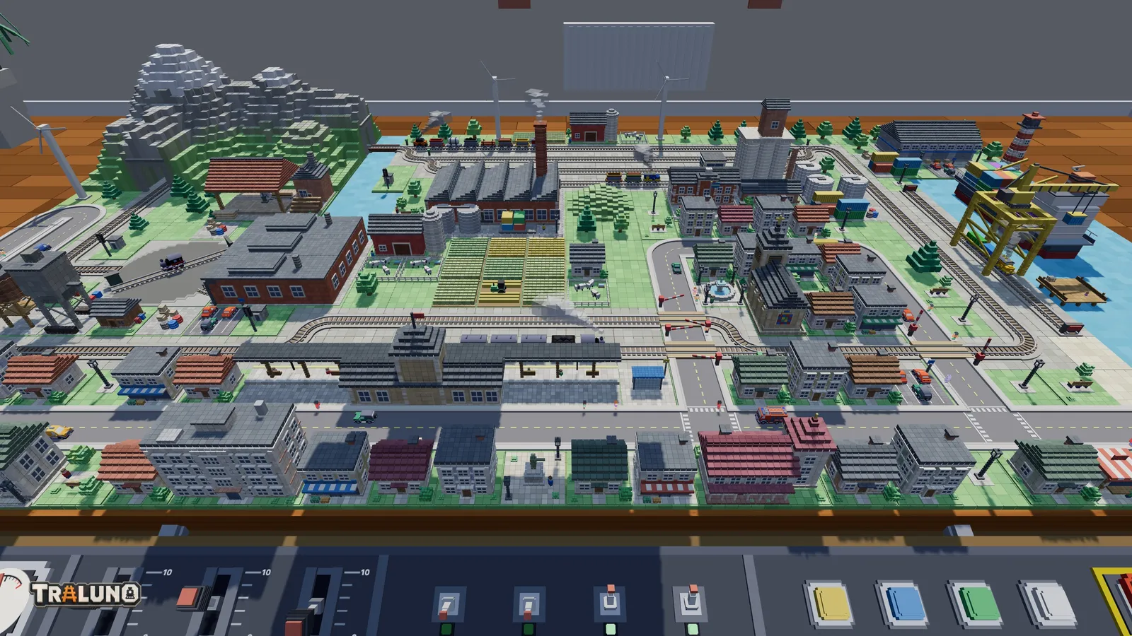 The demo layout from the Stand view at the front edge of the table: rows of roofs, the station canopy and the streets, with the control desk across the bottom of the picture.